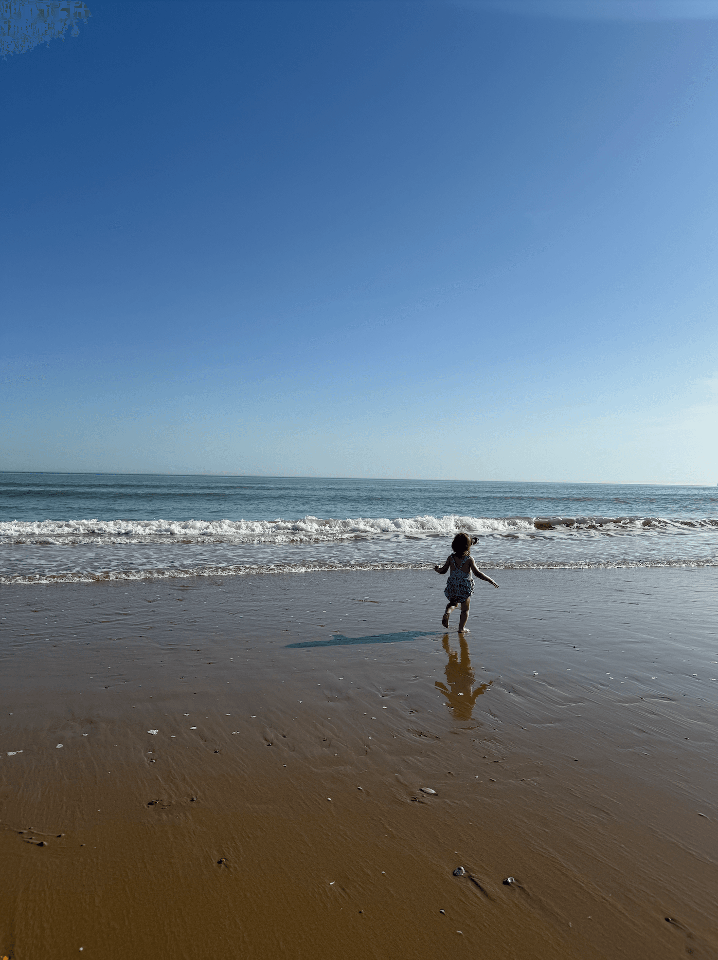 Child running into the sea at Camber Sands